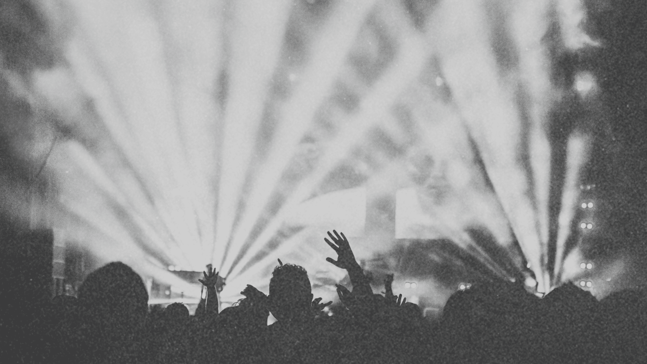 A high-energy event with vibrant lighting, a packed dance floor, and an enthusiastic crowd dancing—showcasing how to make your event stand out in 2025.